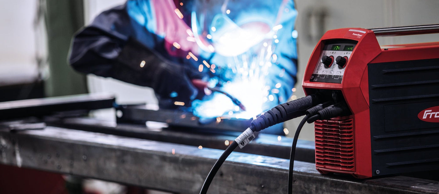 Man welding with Fronius machine